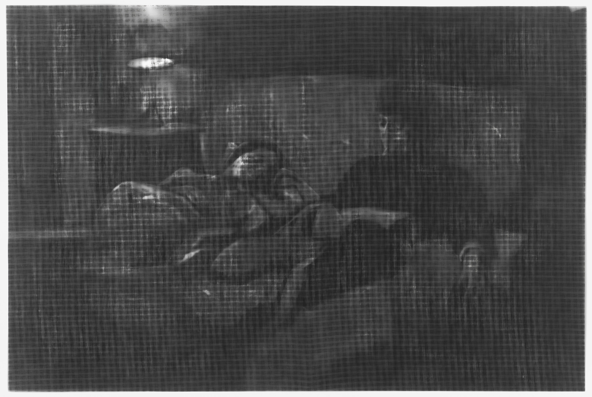 A grayscale, blurry image depicting what appears to be a dimly lit interior scene with indistinct figures and objects, giving the impression of a painting or an old photograph. The lack of clear details makes it difficult to discern specific elements within the scene.