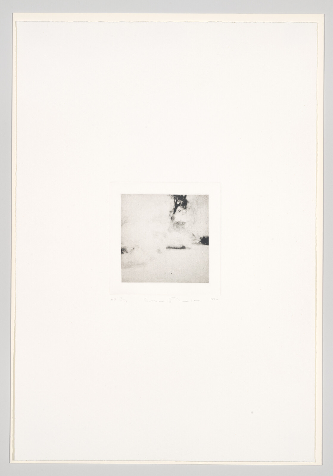 A minimalist artwork featuring a small, centered, abstract monochrome image on a large white background, with some handwritten text or marks at the bottom edge of the image.