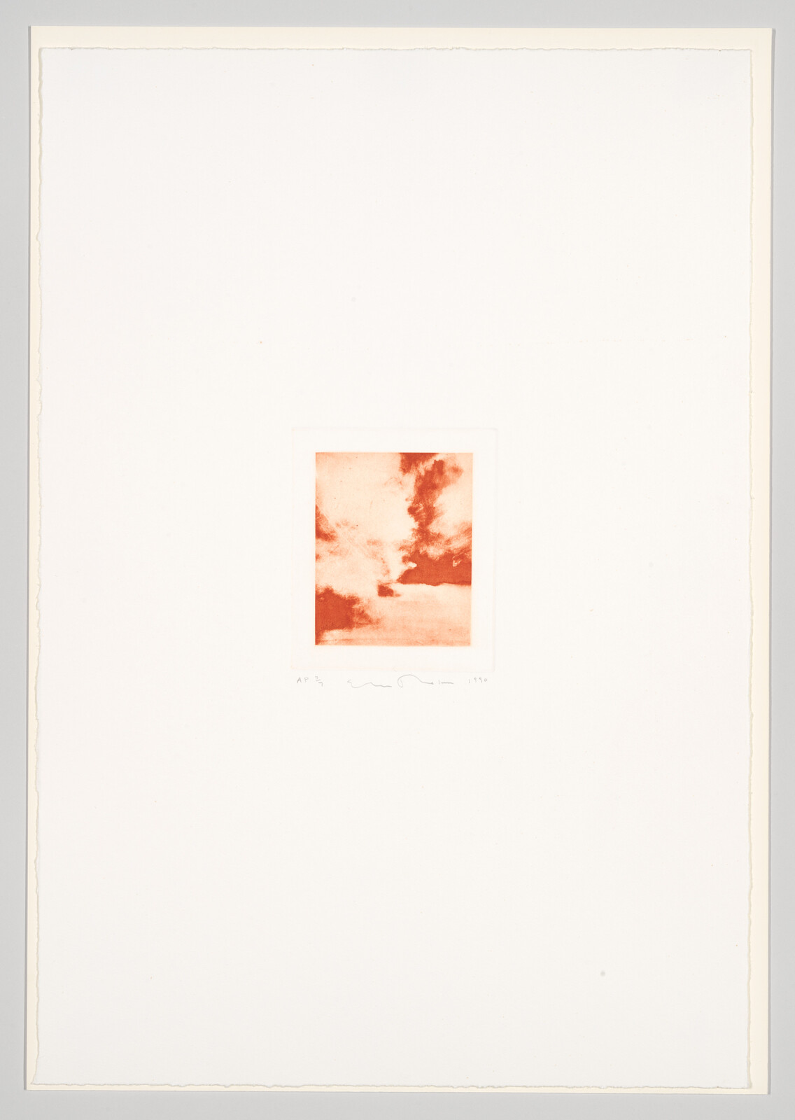 A small square sepia-toned photograph of clouds in the sky is centered on a large white mat. Below the photograph, on the mat, there is a handwritten inscription with a signature and date. The edges of the mat show slight discoloration, suggesting age.