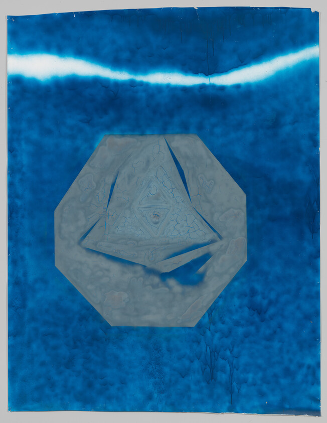 Large blue abstract print with a gray octagon containing a faint triangular relief at center.