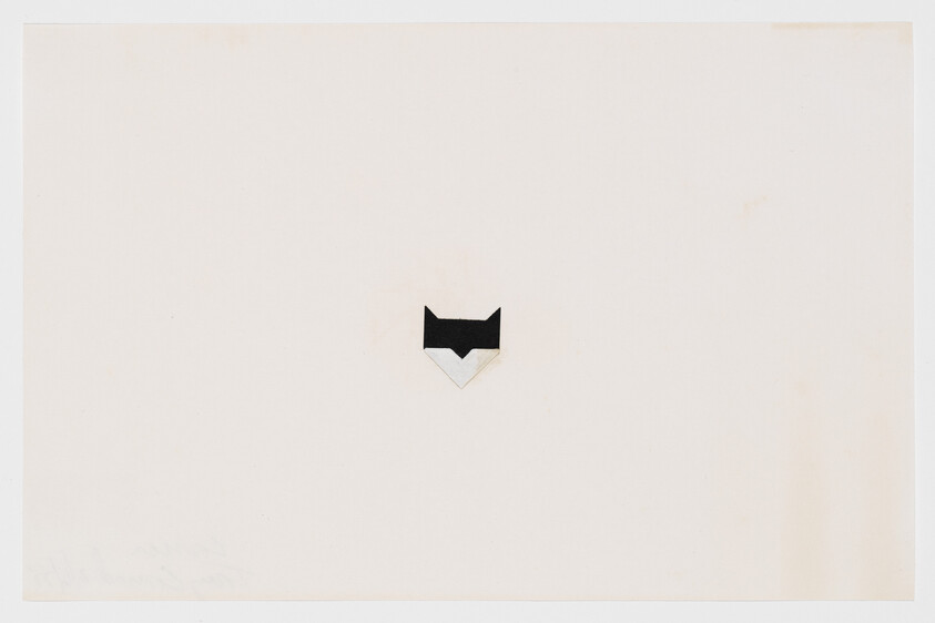 A small geometric black-and-white fox face centered on a wide pale background.