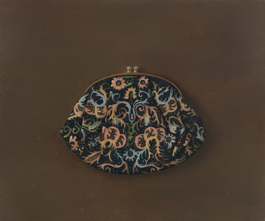 A small clasped coin purse with intricate multicolored floral beadwork rests on a brown background.