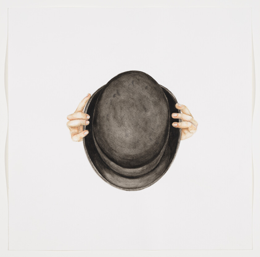 Two hands hold a black bowler hat centered against a plain white background.