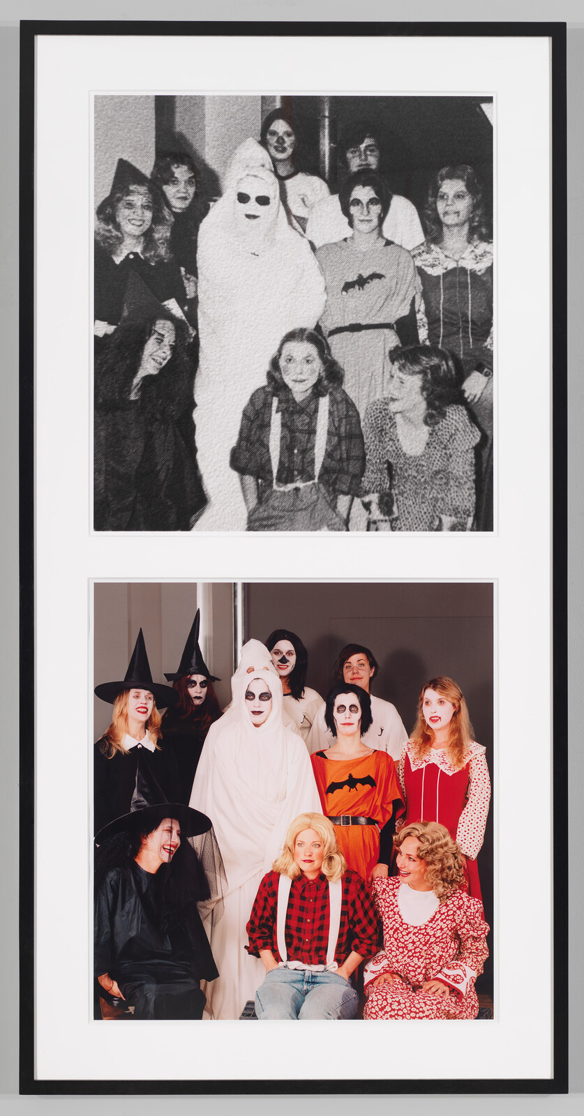 A group of people in Halloween costumes, including a ghost and witches, pose for a portrait.