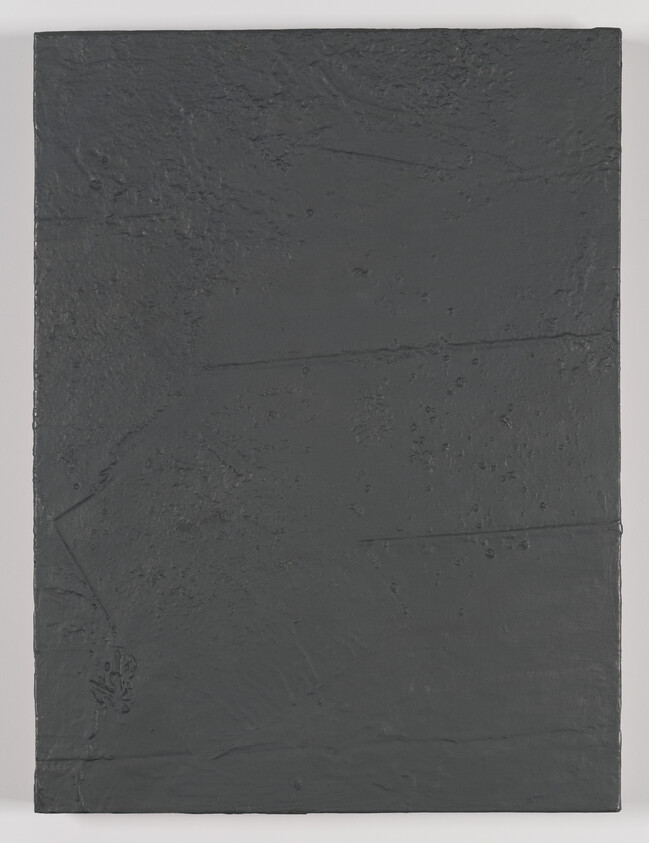 Dark gray rectangular canvas with rough textured surface and subtle scratches and bumps.