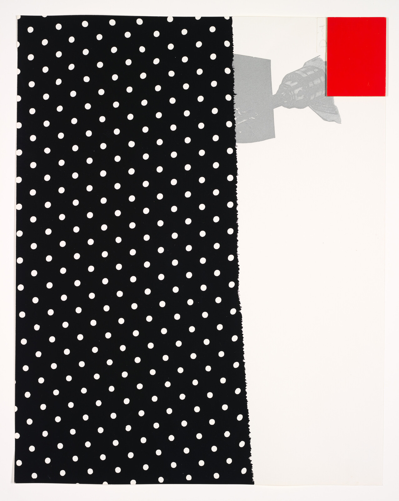 Large torn black panel with white polka dots beside a blank white area with a small red rectangle.