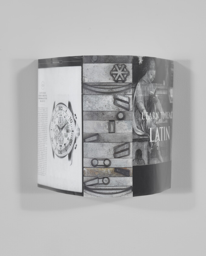 A folded book cover mounted on a wall showing a watch image, carved panels, and 'Learn to read Latin' text.