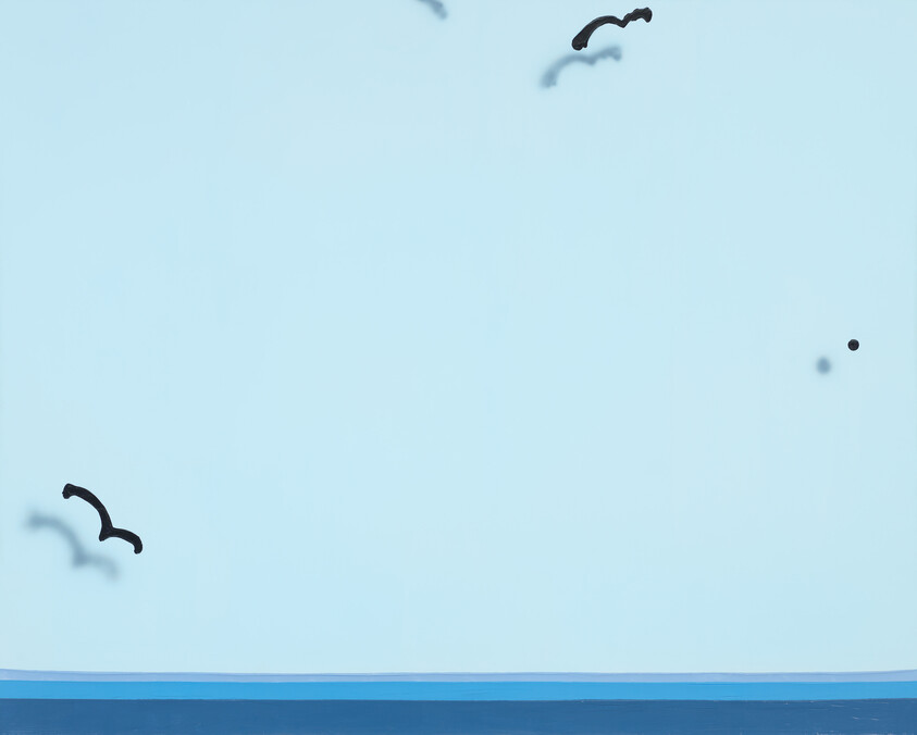 A minimalist image showing a clear blue sky above a calm blue sea horizon with two black silhouetted birds in flight and two small black dots, possibly birds at a distance, against the sky.