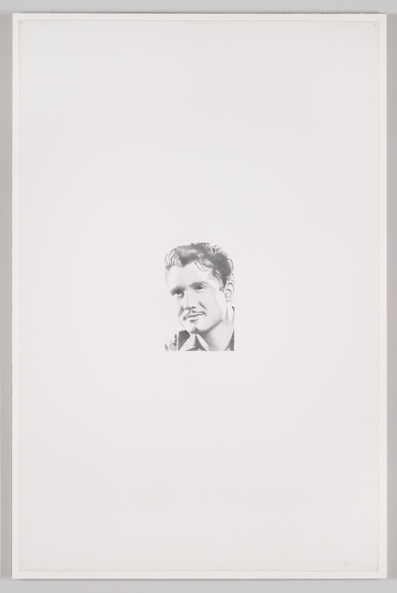 A small black-and-white portrait of a smiling young man centered on a large white background.