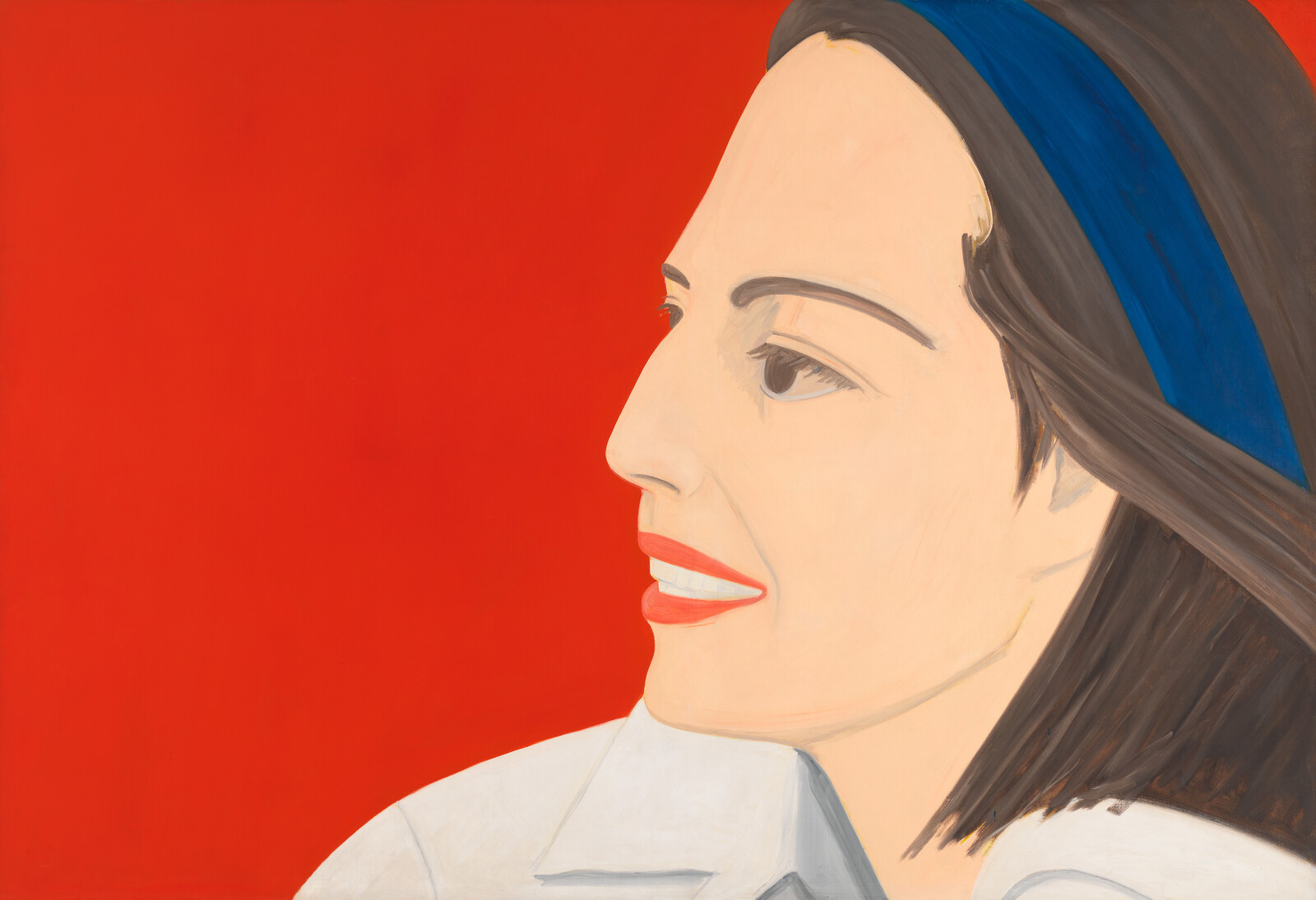 A woman wearing red lipstick smiles softly, her face in profile against a more vivid red background.