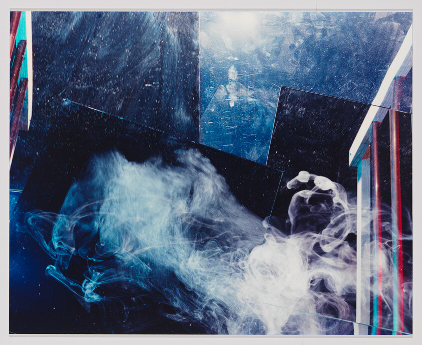 White smoke or mist swirls in front of dark, shiny panels and colorful vertical lines in an abstract scene.