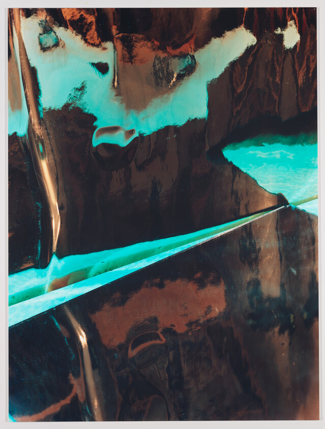 Shiny brown and turquoise surfaces with a glowing diagonal seam creating an abstract reflective composition.