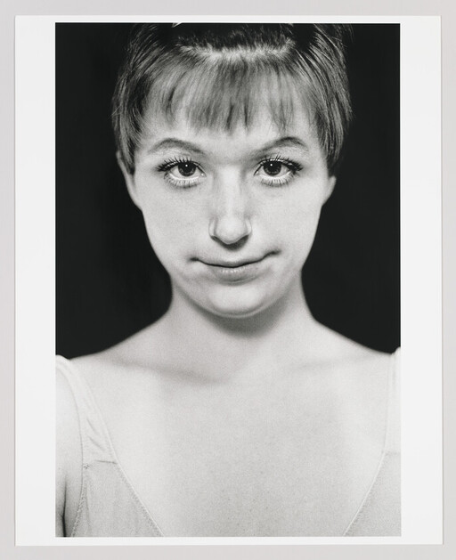 Young woman with short bangs and a slight smile looking directly at the camera.