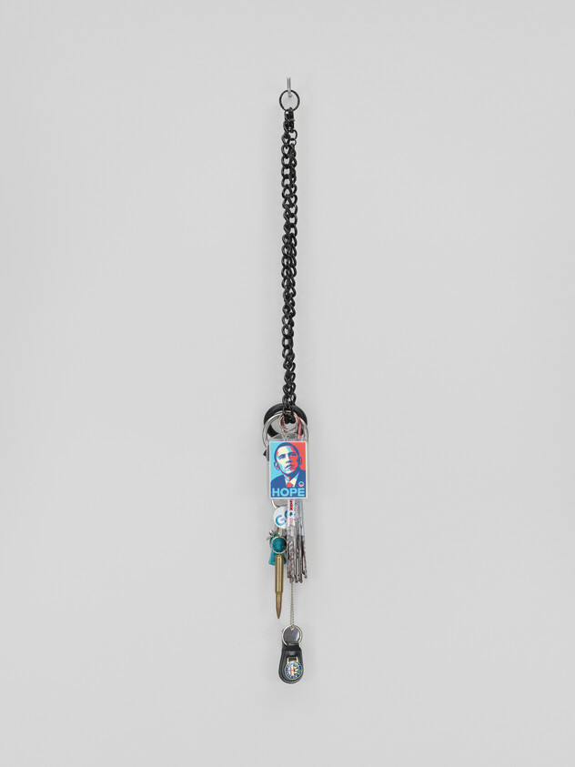 Keychain with multiple keys and an Obama Hope sticker hanging from a black chain.