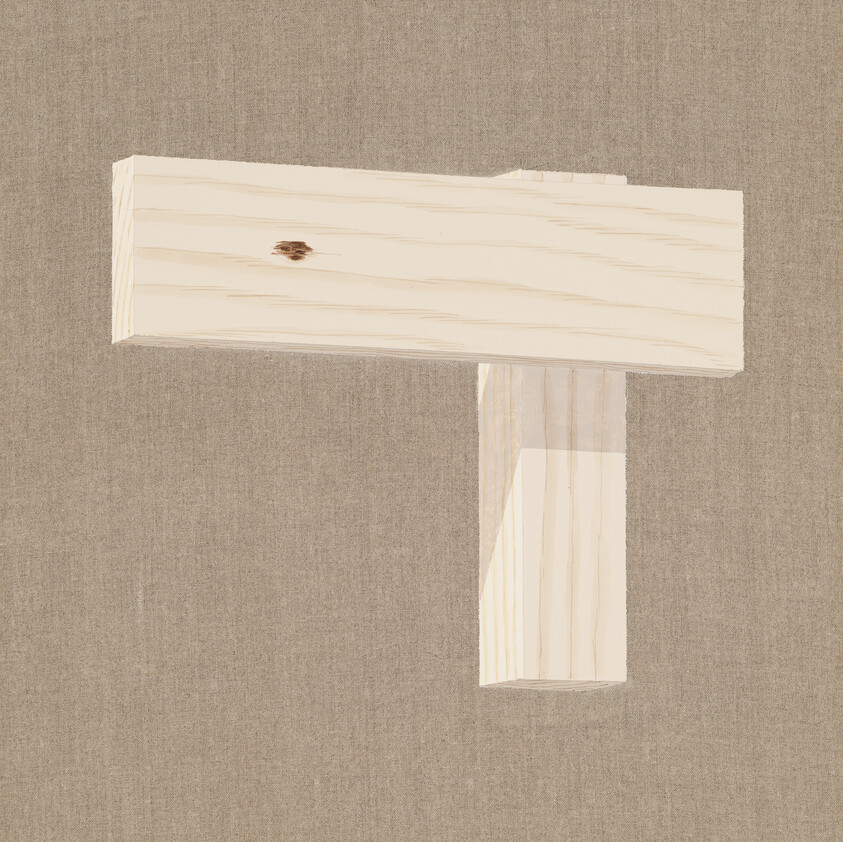 Two light wooden planks arranged in a T shape against a textured fabric background.