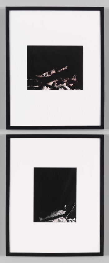 Two vertically stacked framed black-and-white prints showing dark squares with light textured shapes.