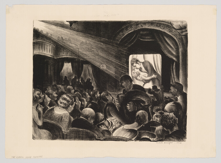 Audience seated in a dim theater watching a touching film of a mother embracing a child on screen.