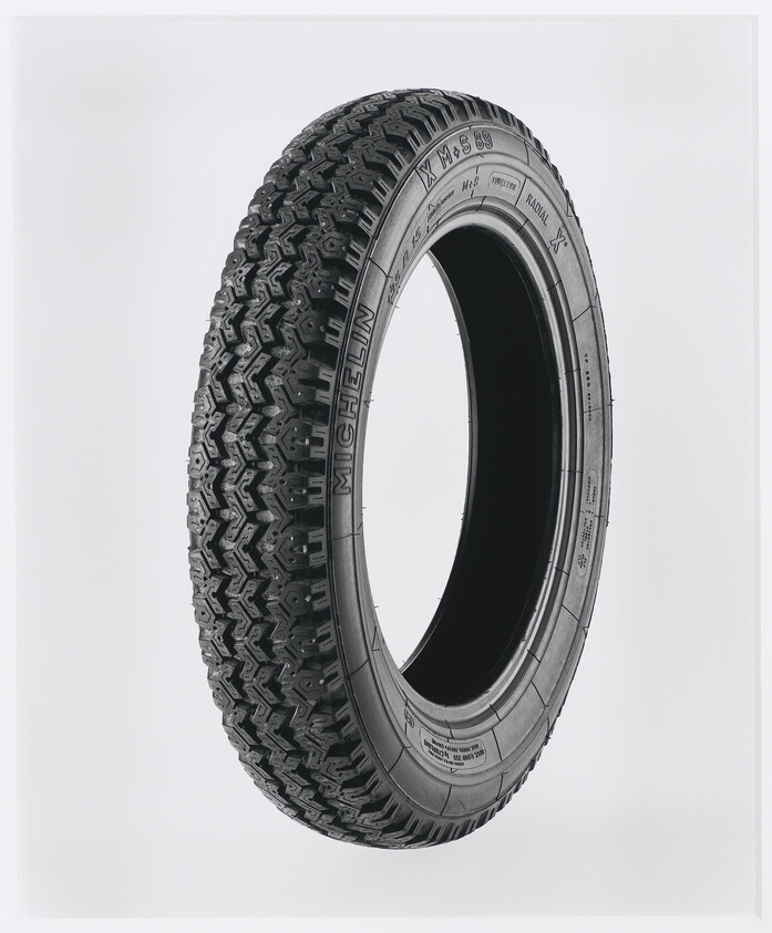 A single black Michelin tire is displayed against a white background, showcasing its tread pattern and sidewall details.