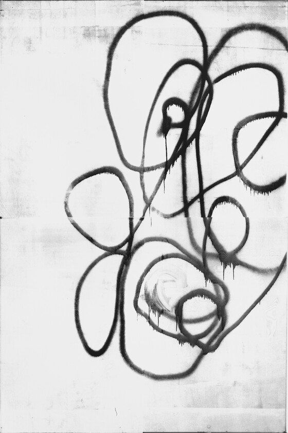 A monochrome graffiti of abstract, curvy lines sprayed in black on a white concrete wall, creating a spontaneous and fluid pattern with some paint drips visible.