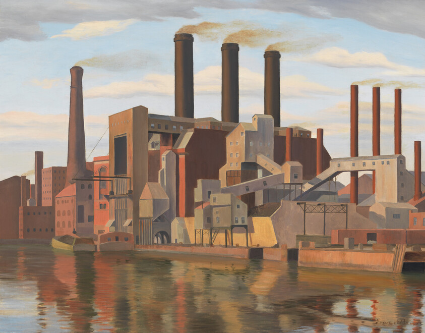 Large riverside factory with tall smokestacks emitting smoke reflected in the water.