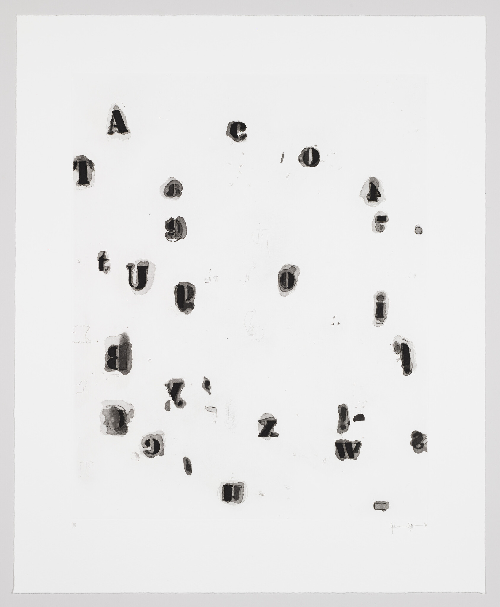 Scattered dark letter shapes and stamp marks are arranged randomly on a white sheet of paper.