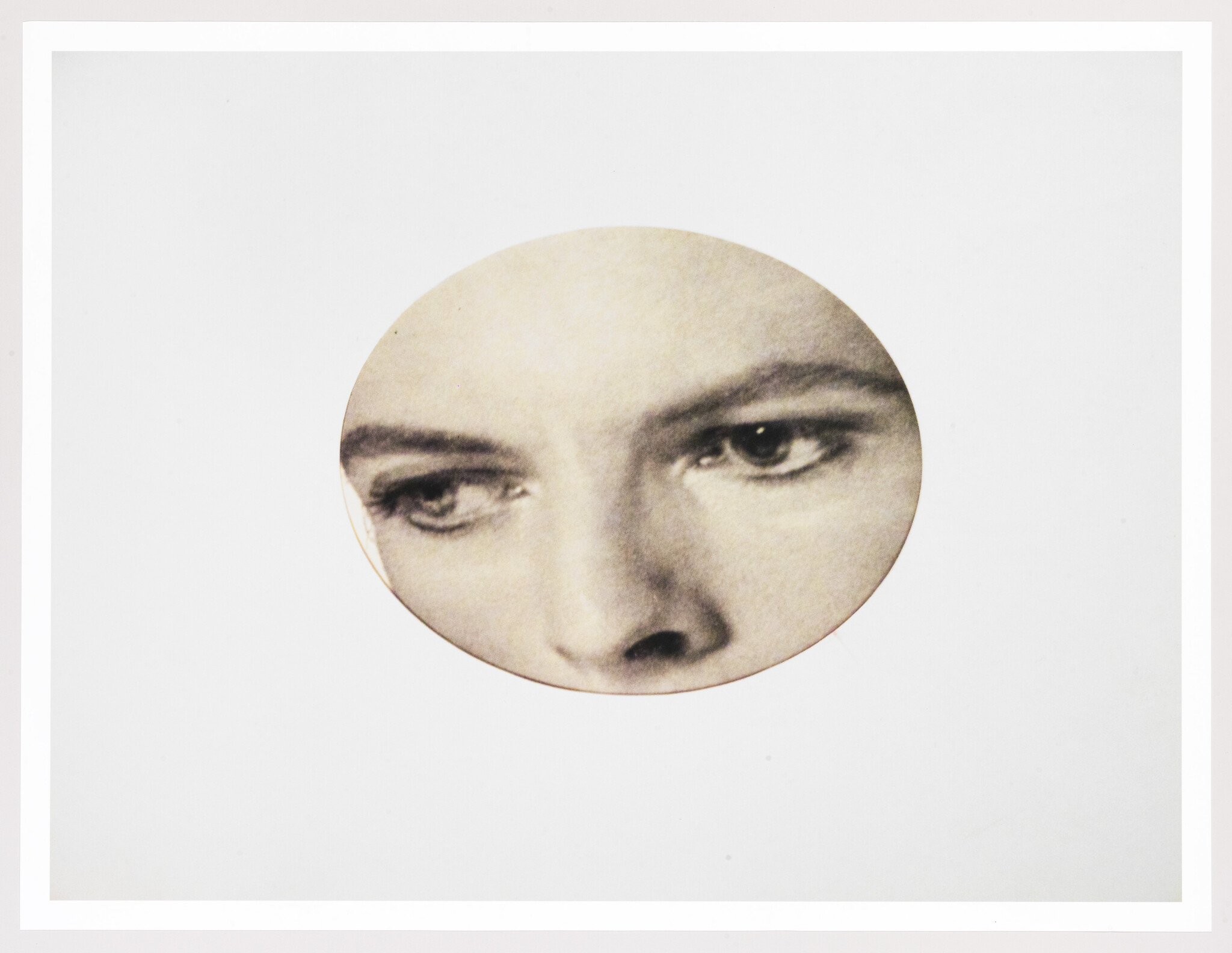 A circular cutout shows a woman's eyes and nose looking downward and slightly to the left.