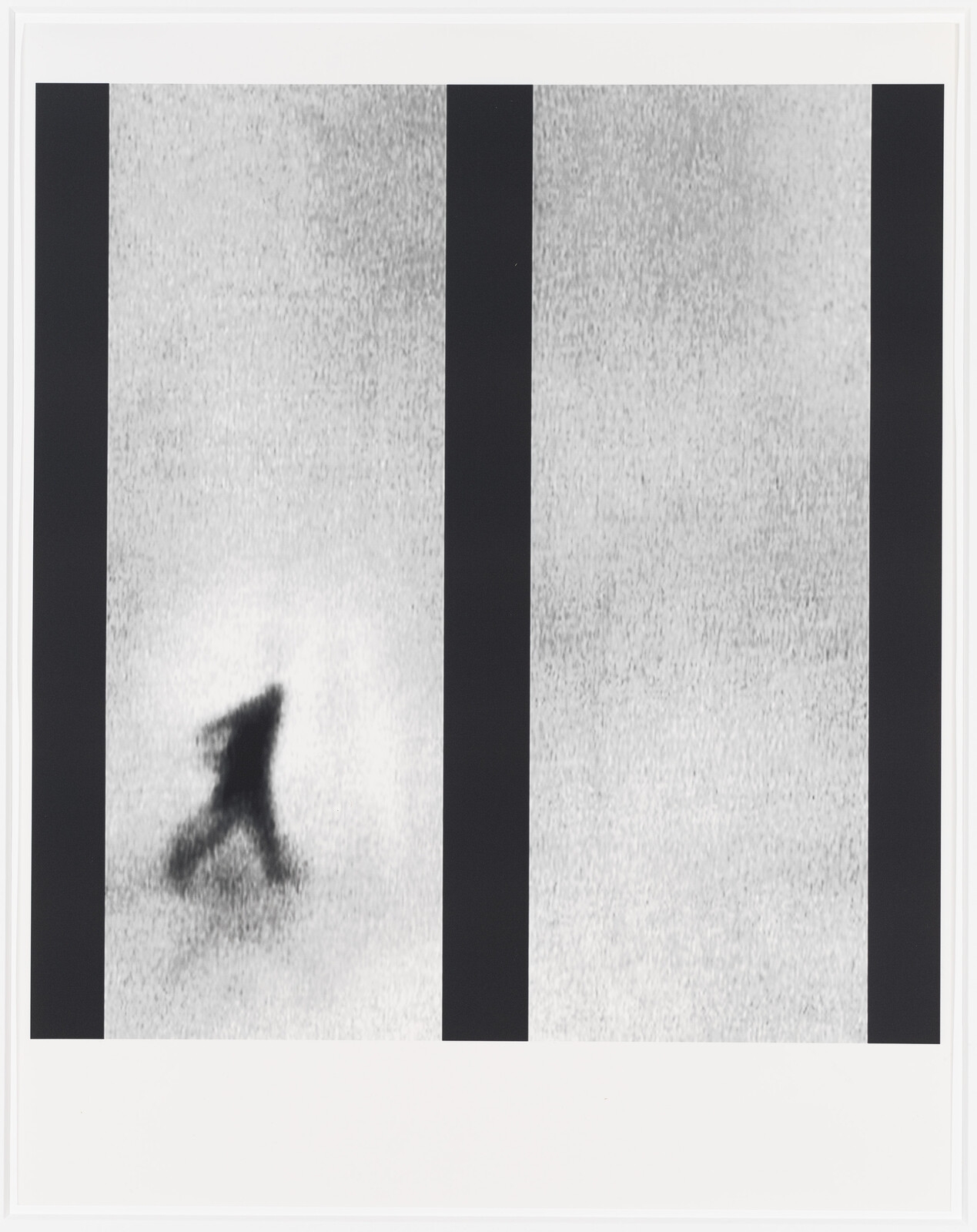 Blurry silhouette of a person walking across a grainy background between vertical black bars.