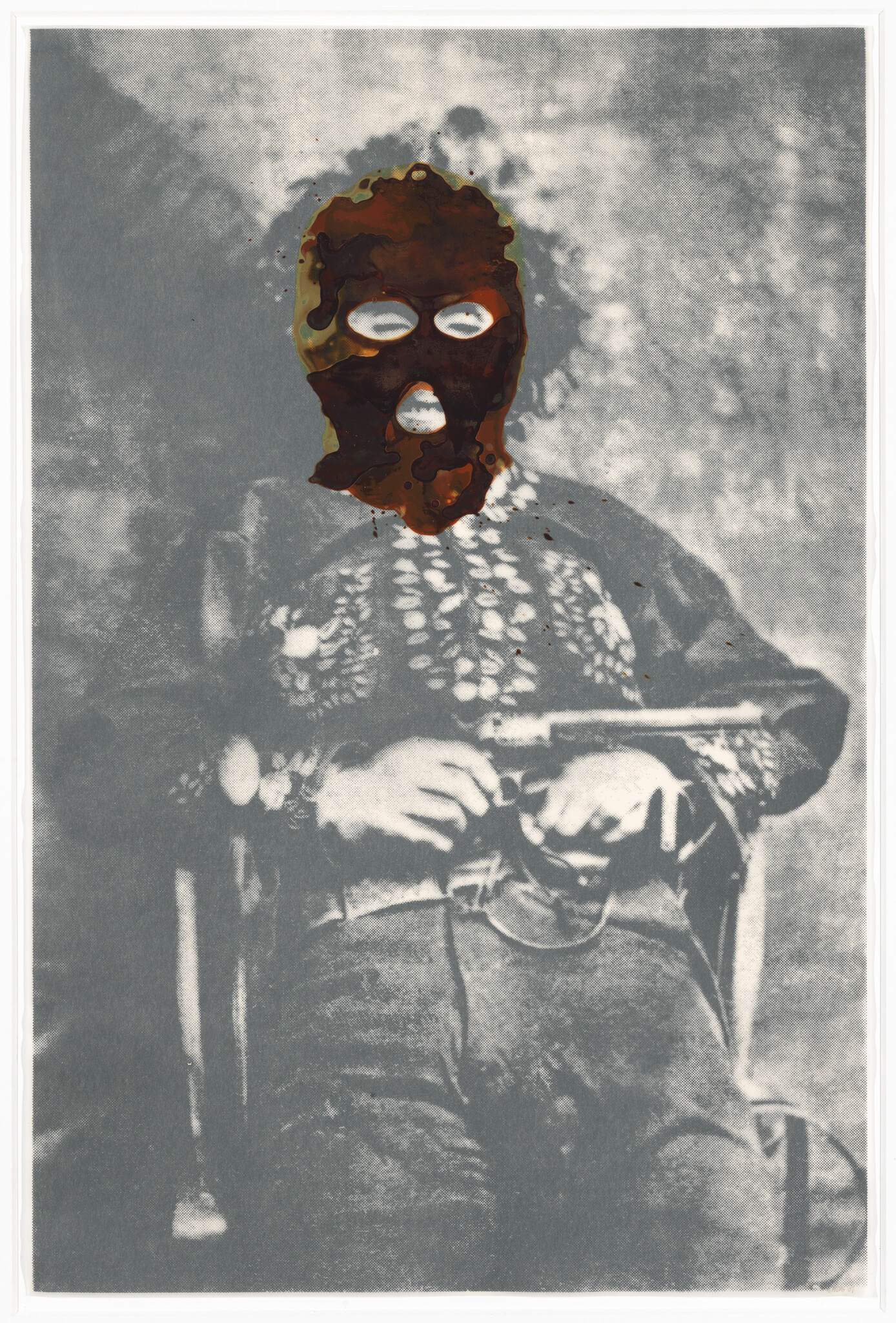 A vintage black and white photo of a person sitting in a chair with severe damage or alteration to the facial area, making the face unrecognizable. The person appears to be wearing period clothing and holding something in their lap. The photo has a textured, aged appearance with some discoloration.