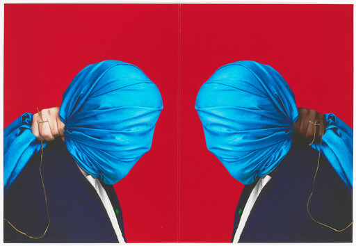 Two mirrored people with bright blue cloths covering their heads pulling the fabric against a red backdrop.