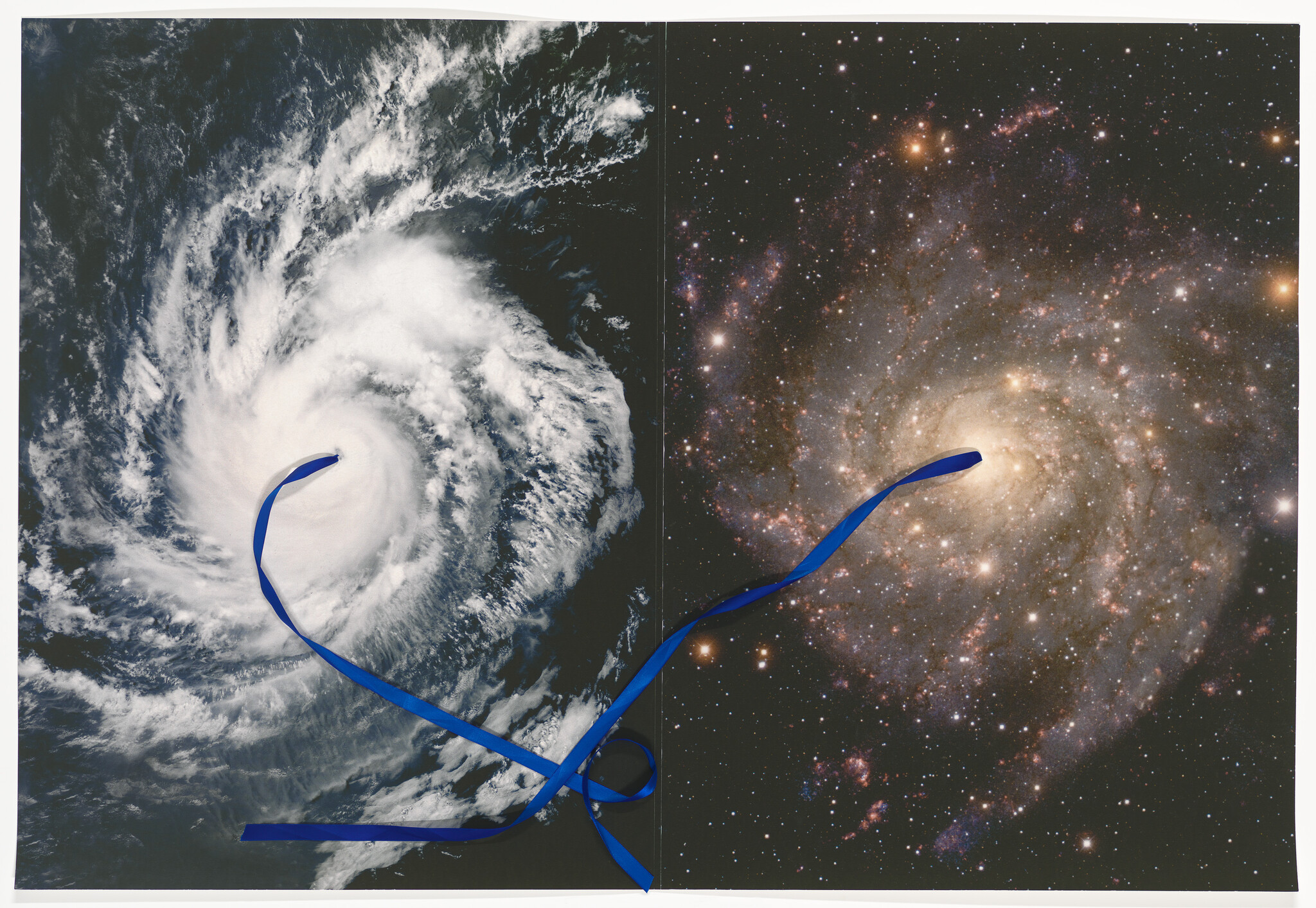 A blue ribbon connects the eye of a swirling hurricane to the bright core of a spiral galaxy.
