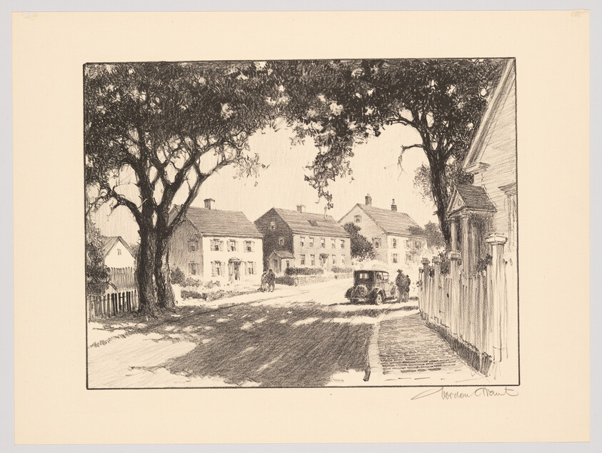 A quiet small-town street shaded by large trees with houses, a parked vintage car, and people.
