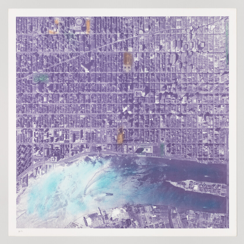 Aerial view of a dense city grid next to a body of water with a few green areas and notable landmarks.