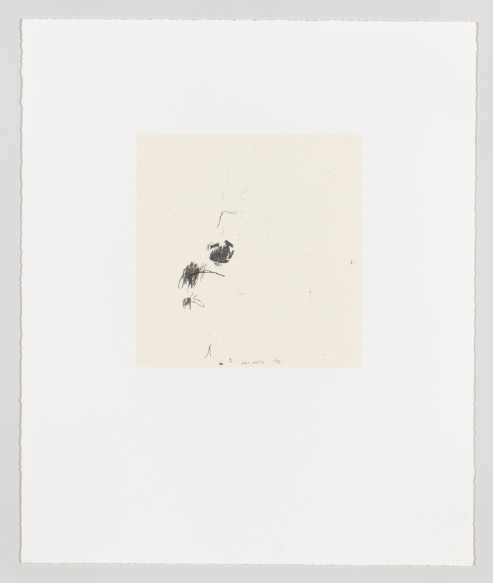 Small abstract black ink sketches cluster in the center of a large white sheet.