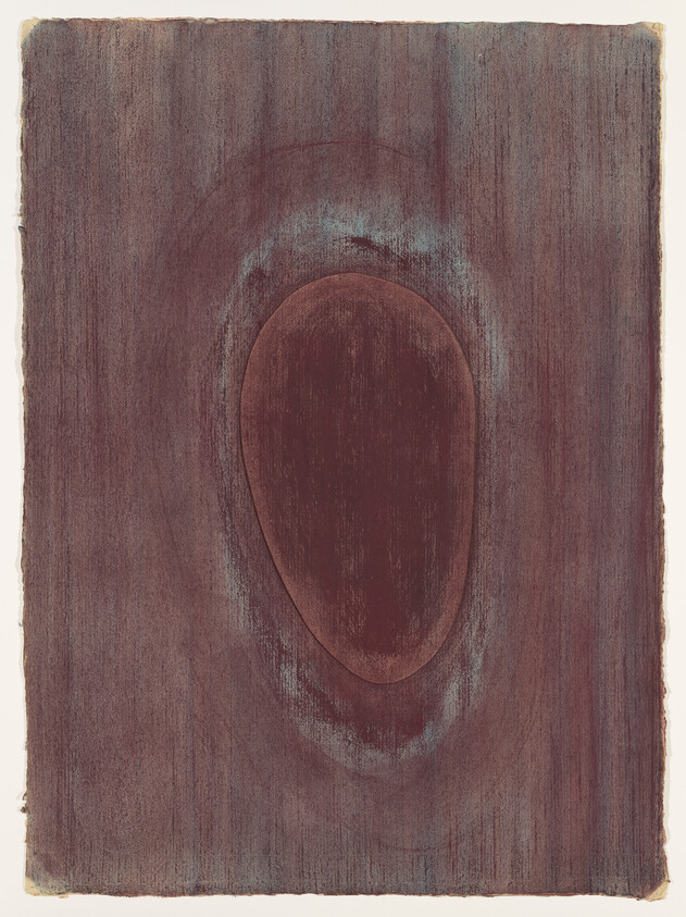 A close-up of a dark brown wood grain with a central oval knot surrounded by faded rings.