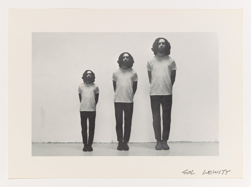 Three identical bearded men in white shirts stand side-by-side in small, medium, and large sizes.