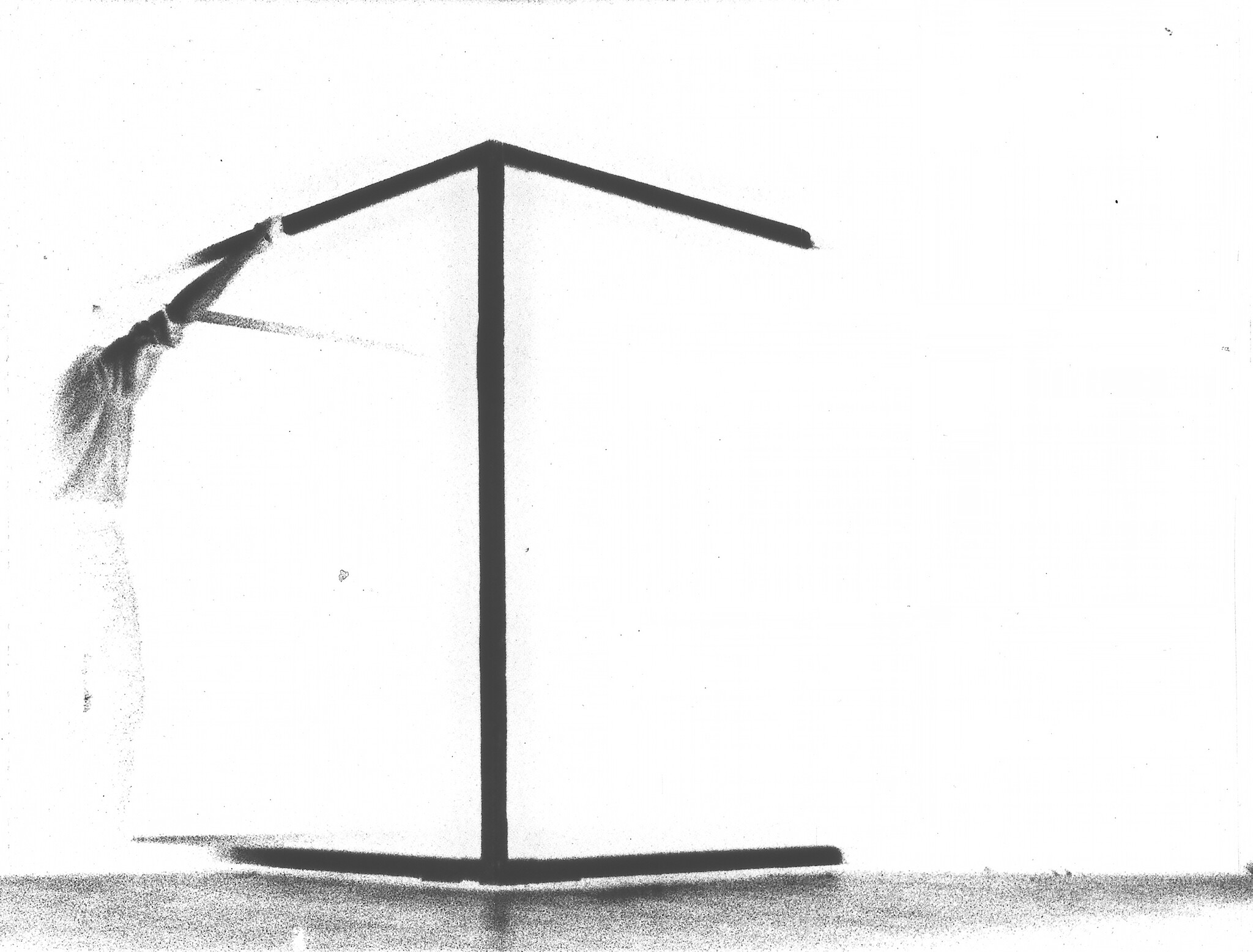 A freestanding coat rack with a single cloth draped over the left upper arm.