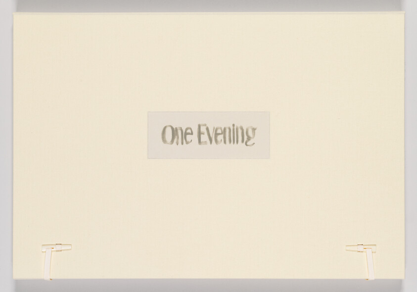 A minimalist artwork consisting of a cream-colored canvas with the phrase "One Evening" cut out in the center, revealing a shadowed background, and the canvas is mounted on a wall with two visible white mounting brackets on the lower corners.