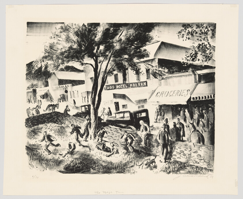 Town street scene with people gathered around a large tree near the Taos Hotel Modern and grocery.