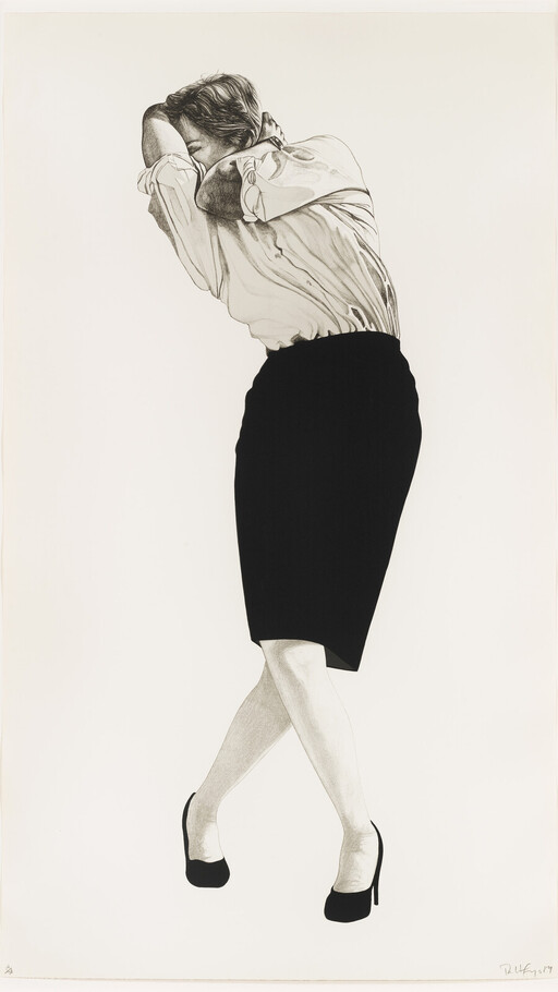 Woman in a skirt and heels folds her arms over her face while standing with crossed legs.