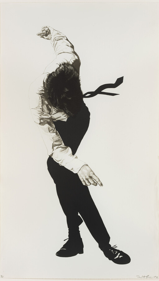A man in dress clothes bends forward with arms extended as if dancing.