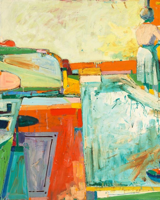 Woman standing by a bright abstract interior with bold blocks of orange, teal, and green.