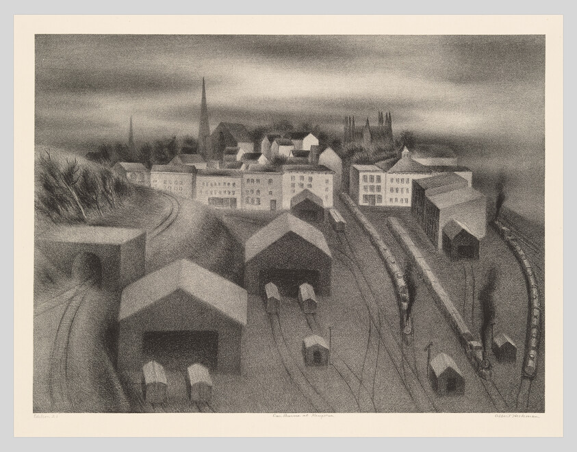 A misty railway yard with engines, freight cars, sheds, and a town with church spires beyond.