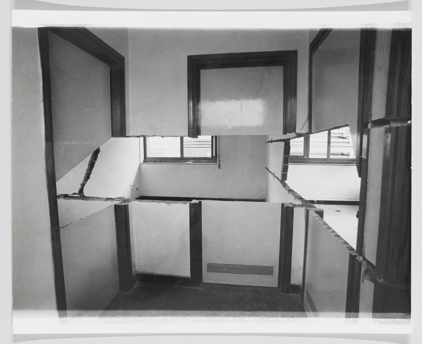 Partition walls have been cut through horizontally, creating open gaps between rooms and exposing windows.