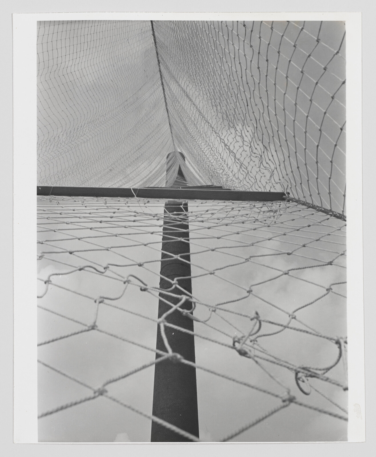 Tall pole rises through layered netting with diamond-shaped mesh stretching overhead.