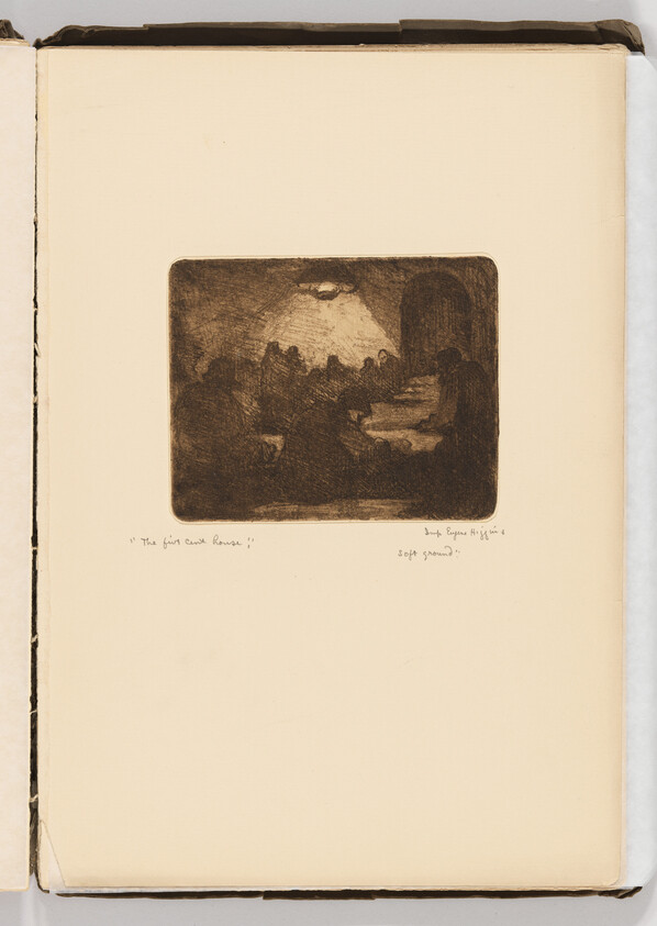 A group of people gathered around a table under a single overhead lamp.