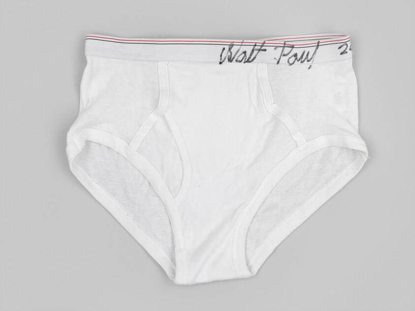 White cotton men's briefs laid flat showing elastic waistband and classic brief cut.