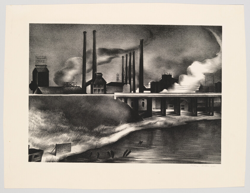 Several tall smokestacks rise above a factory complex beside a bridge over a river.