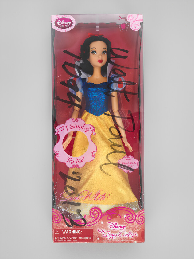 Snow White singing doll in original Disney Store box wearing blue and yellow dress with marker scribbles.