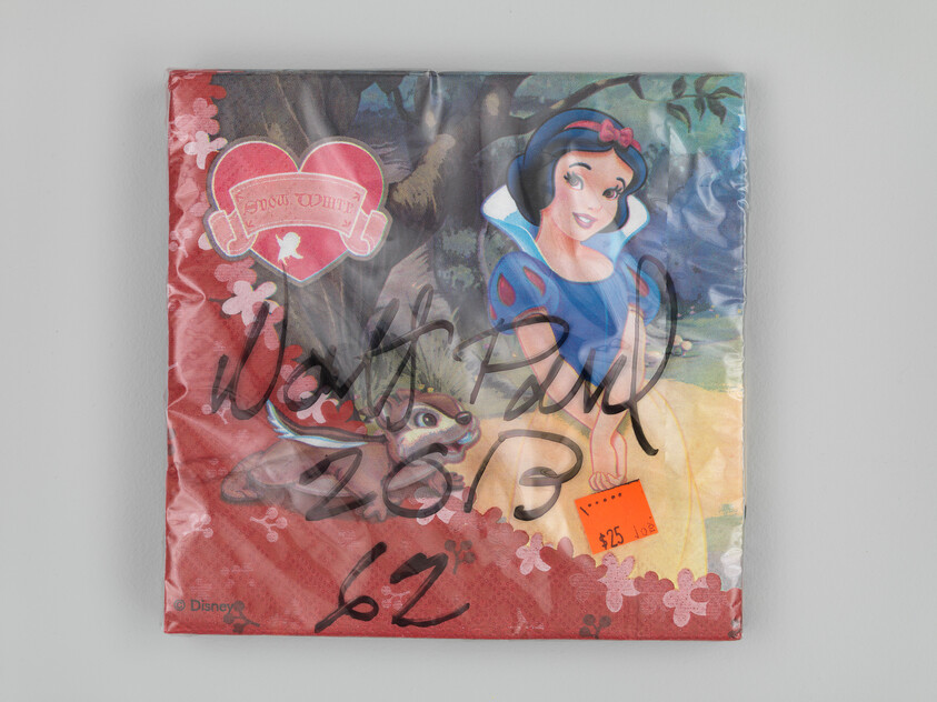 Packaged Snow White paper napkins with an orange $25 price sticker and black marker scribbles.