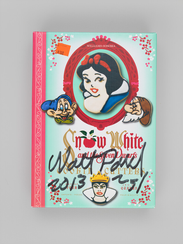Snow White-themed cookie cutter set box with character cookies and handwritten marker scribbles.